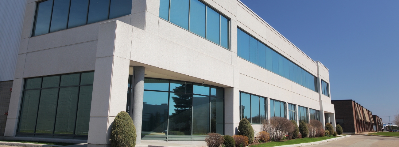 Illustration showing commercial buildings with tax documents and dollar signs, representing tax changes impacting commercial real estate in 2025